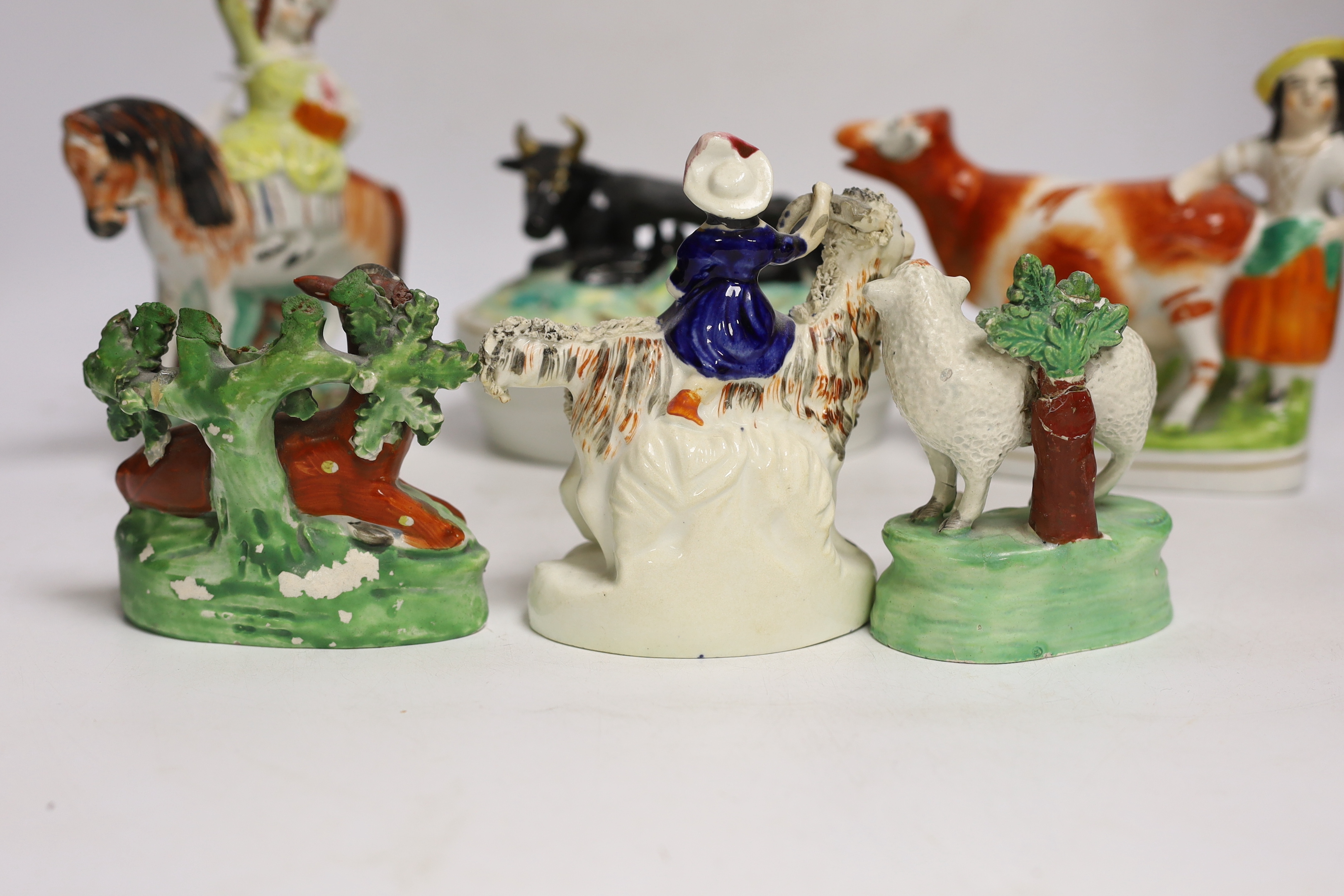 A Victorian Staffordshire cow tureen and cover, and five other Staffordshire figures, largest 18cm wide